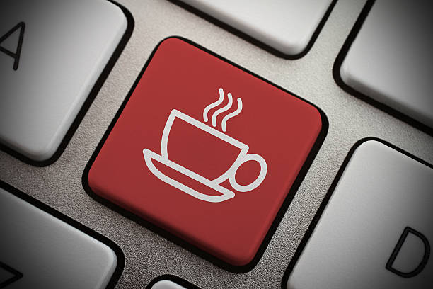 Red coffee icon key on a gray keyboard close-up stock photo