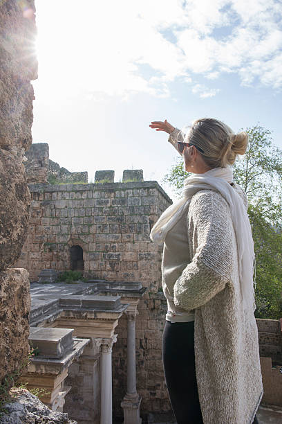 istock Woman relaxes on castle ramparts, Hadrian's Gate 471664968