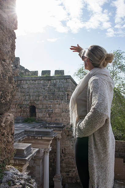 istock Woman relaxes on castle ramparts, Hadrian's Gate 471664992