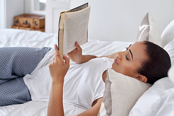 istock woman book relaxing bed 471665606