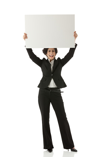 Smiling businesswoman showing placardhttp://www.twodozendesign.info/i/1.png