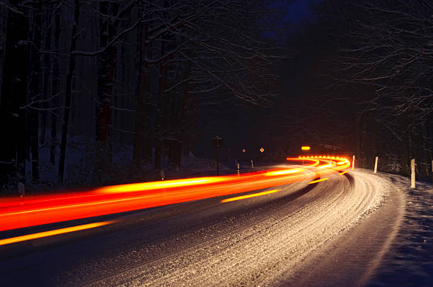 istock Traffic in a snowy curve 471667687