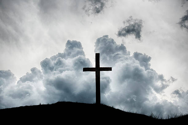 istock Christian Cross on Hilltop with Dramatic Clouds 471668319