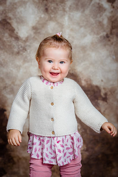 istock Cute little girl with grey eyes laughs and dances 471670008