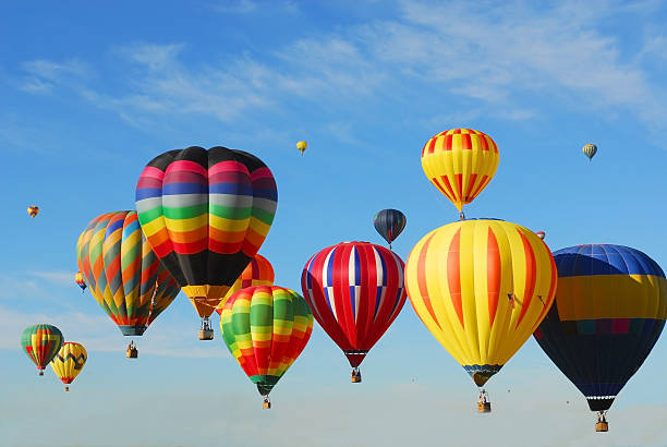 Flying High in the Sky Colorful hot air balloons flying high in the sky at a Balloon Festival in the fall near Albuquerque, New Mexico. hot air balloon photos stock pictures, royalty-free photos & images