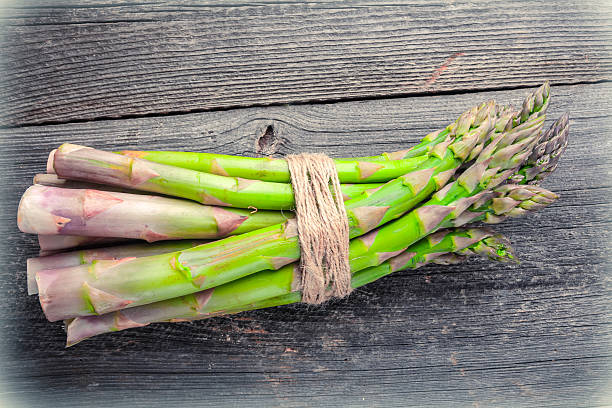 istock Fresh asparagus on wooden table 471671238