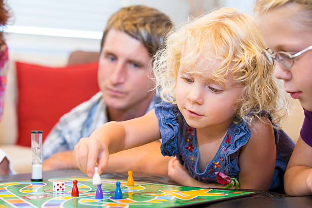 istock Little girl contemplating her next game move 471671605