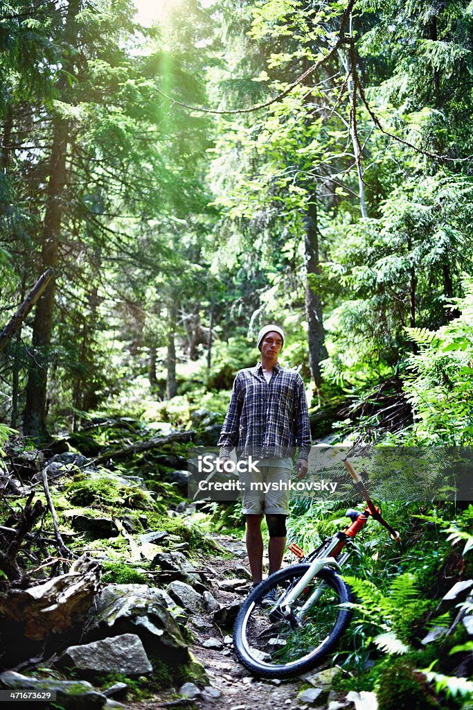 Cyclist at mountain forest http://i445.photobucket.com/albums/qq173/myshkovsky/mountain_biking_zps38d8bf55.jpg 20-24 Years Stock Photo