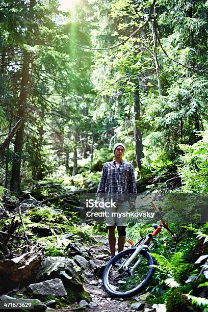 Cyclist At Mountain Forest Stock Photo - Download Image Now - 20-24 Years, Adult, Adults Only