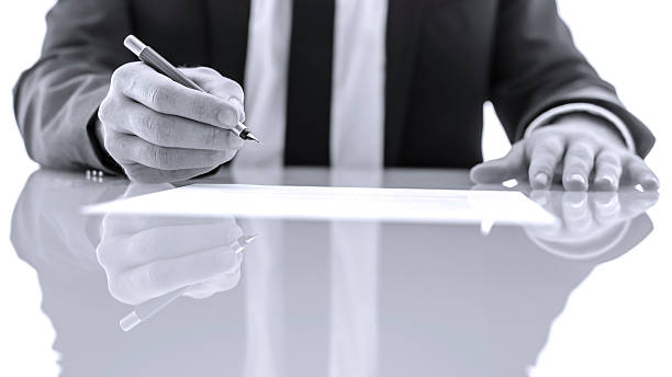 istock Signing and reading legal papers 471674063