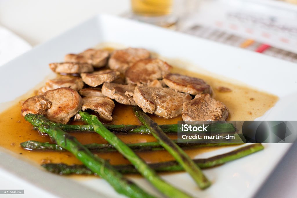 Main course of meat and asparagus Roasted filet with grilled asparagus 2015 Stock Photo