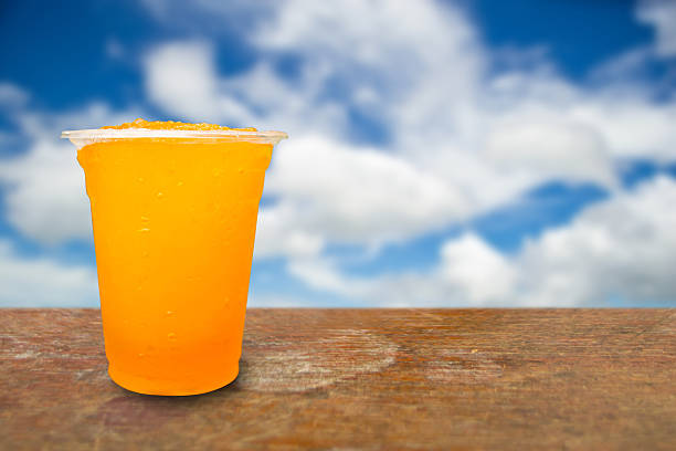 istock Orange juice in plastic cups on a background 471674482