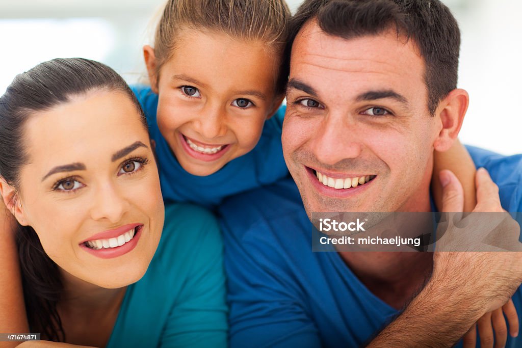 cute family face closeup cute family of three face closeup portrait at home Adult Stock Photo