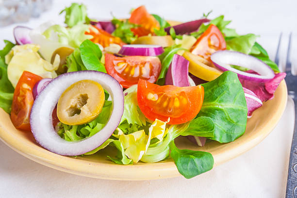 istock Vegetarian salad with lettuce, tomatoes, olives and onions 471675238