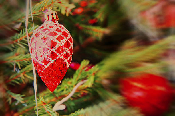 istock Red Christmas balls on spruce branch with soft bokeh. 471675798