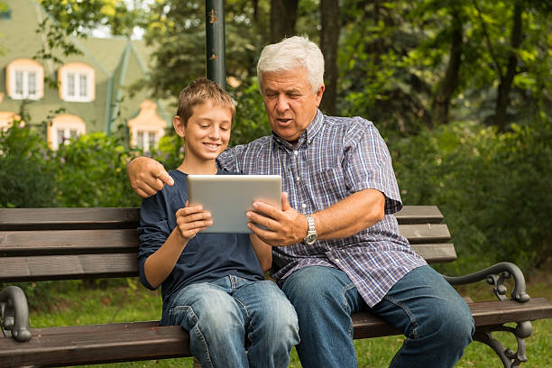 istock Grandfather and grandson in the park 471675867