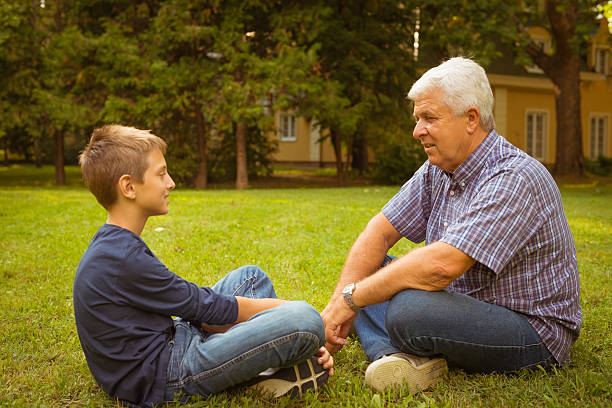 istock Grandfather and grandson in the park 471675935
