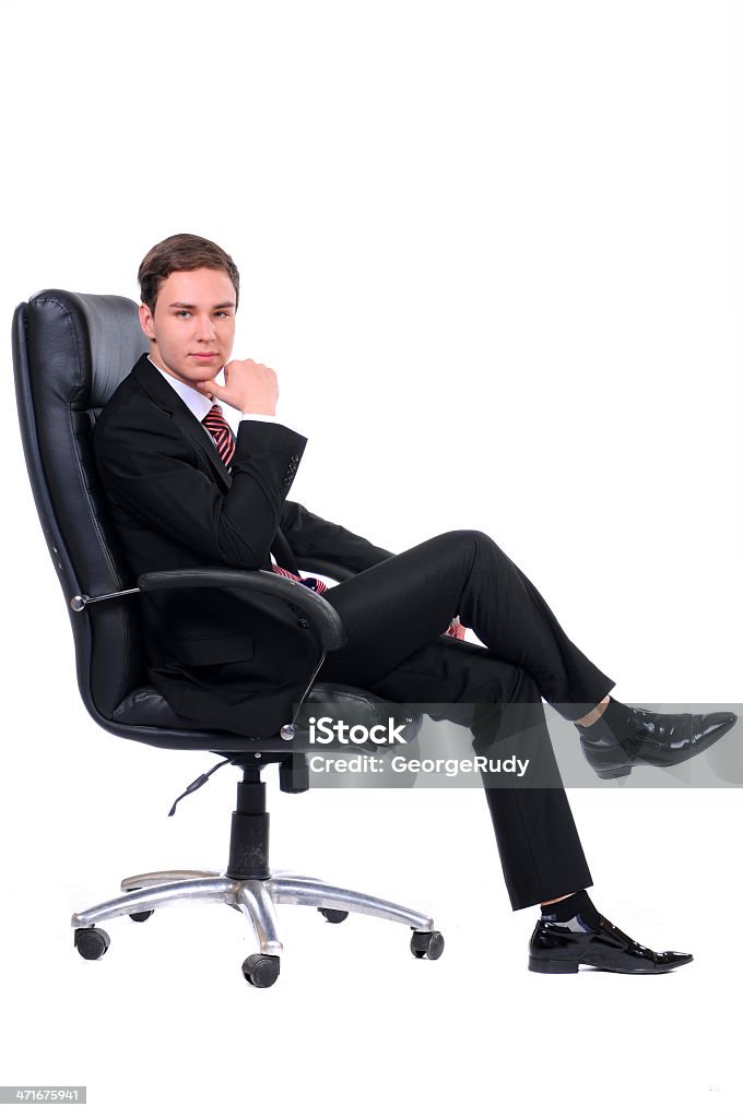 Business A young businessman sitting in office chair isolated on a white background Adult Stock Photo