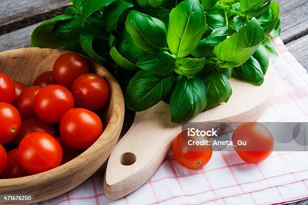 Fresh Cherry Tomatoes And Basil Leaves Stock Photo - Download Image Now - 2015, Backgrounds, Basil