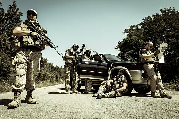 Modern Army Soldiers Guarding a Roadblock with Car stock photo