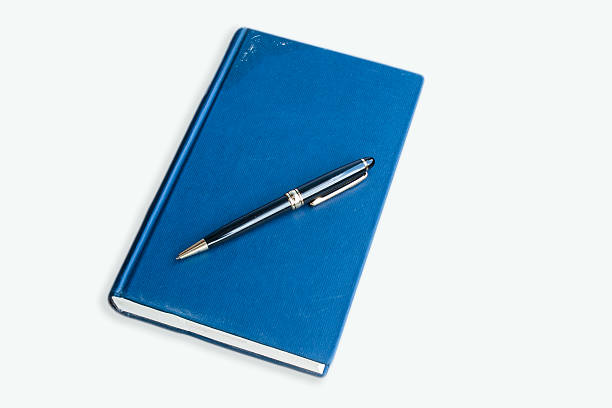 istock blue hardcover book with pen 471676935