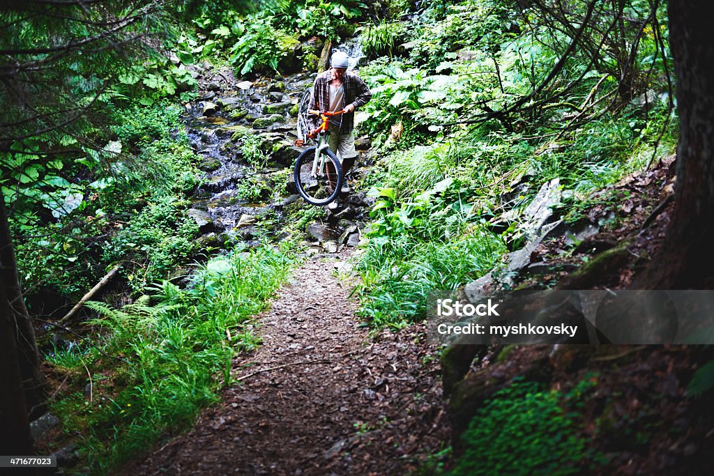 Ciclista di Mountain bike e attraversare il fiume - Foto stock royalty-free di 20-24 anni