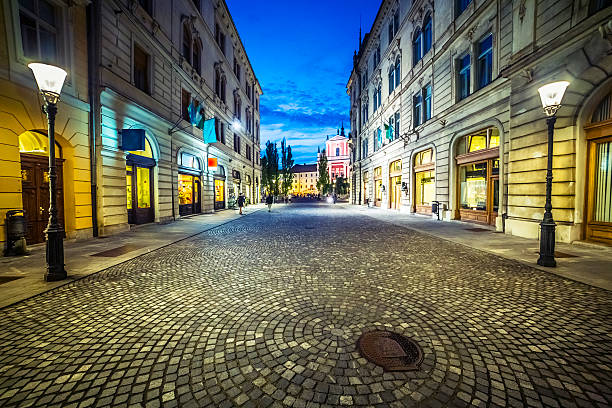 istock Wide empty old European street at night 471677391