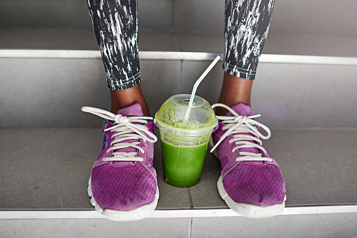 Cropped shot of a cup of juice between a female athlete's feethttp://195.154.178.81/DATA/i_collage/pu/shoots/804512.jpg