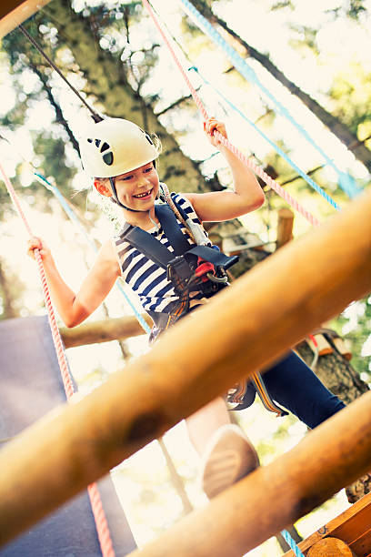 istock Little girl walking on the ropes course 471677537