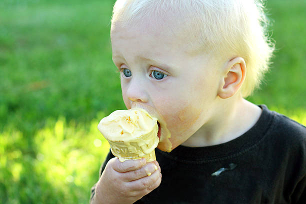 istock Messy Baby Licking Ice Cream Cone 471678029