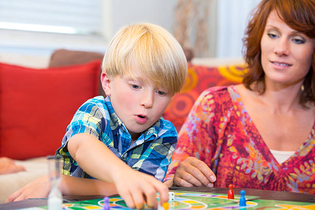 istock Little boy contemplating his next game move 471678705