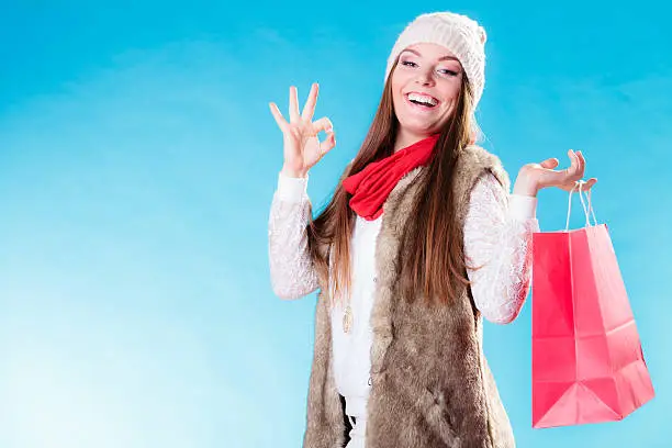 Photo of Winter girl with red paper shopping bag