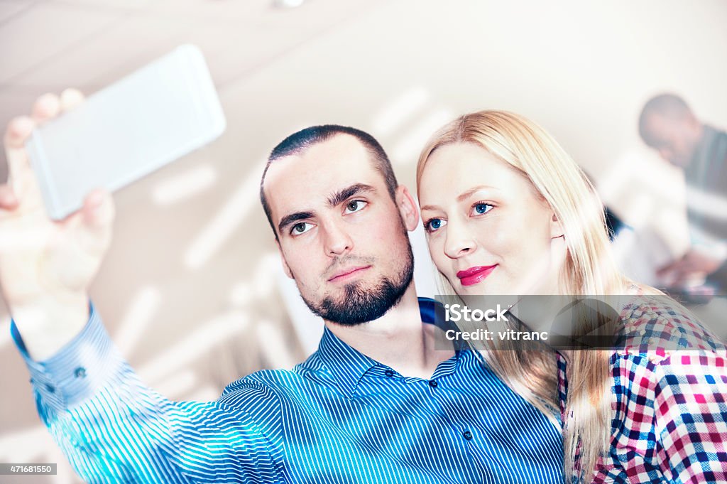 Taking Selfie with Mobile phone Couple taking selfie with mobile phone .Focus on couple 2015 Stock Photo