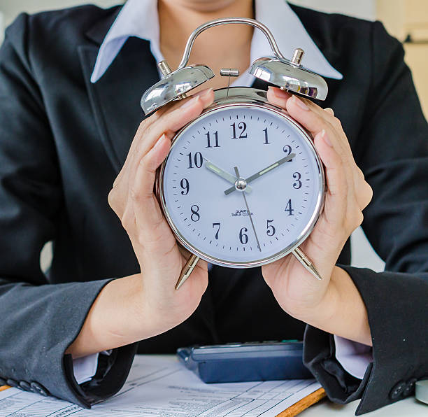 istock Young business women with clock 471682595
