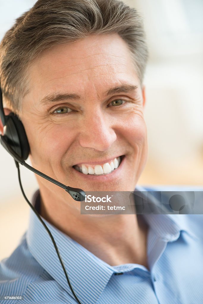 Happy Customer Service Representative Wearing Headset Portrait of happy male customer service representative wearing headset 40-44 Years Stock Photo