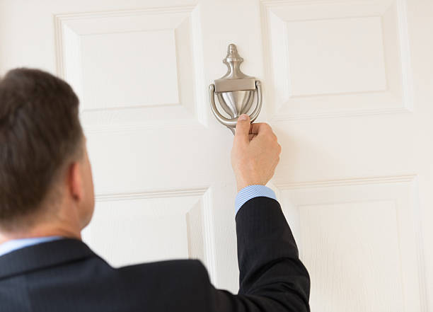 Businessman Knocking Door Knocker Rear view of mature businessman knocking door knocker knocking on door stock pictures, royalty-free photos & images