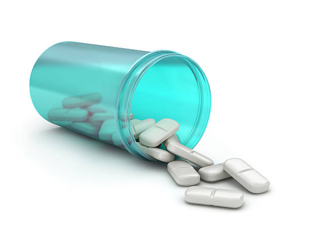 istock Pills spilling out of pill bottle isolated on white 471687062