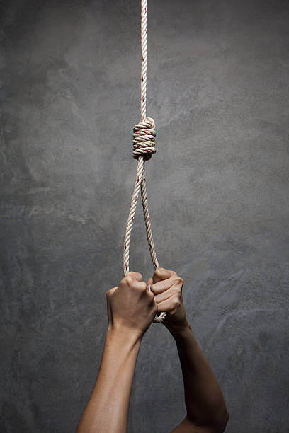 istock Hands holding rope slipknot in concept suicide 471687130