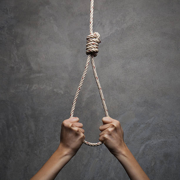 istock Hands holding rope slipknot in concept suicide 471687142