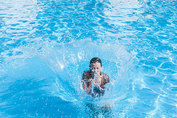 istock Girl jumping in the pool 471687476