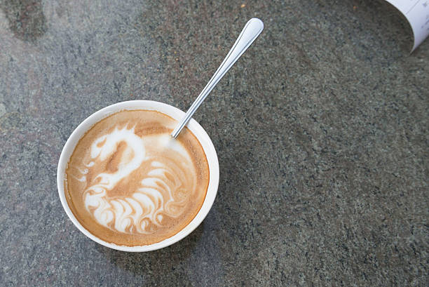 Latte Art Coffee with Dragon Motive on Marble Table