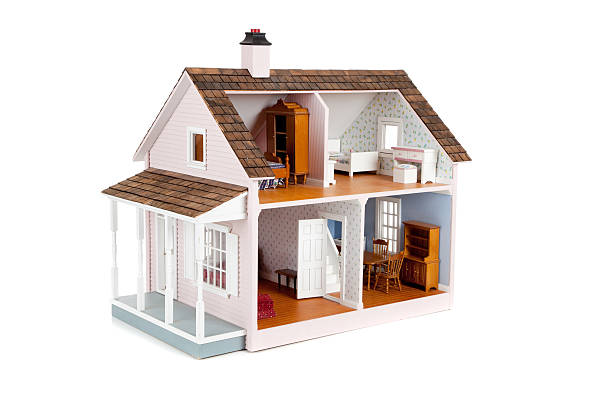 Furnished pink doll house on white stock photo