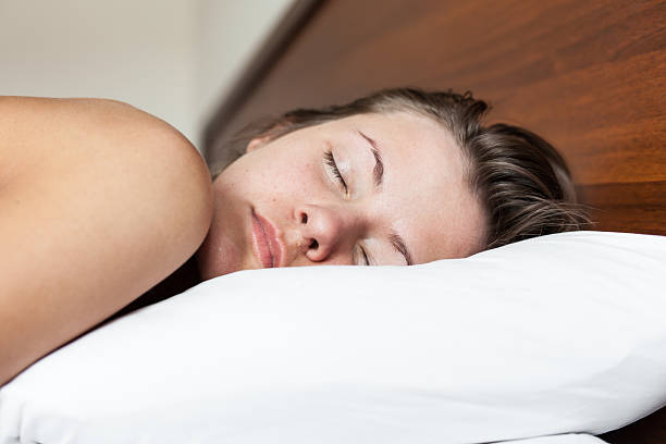 istock Young naked woman sleeping in white bed 471688416