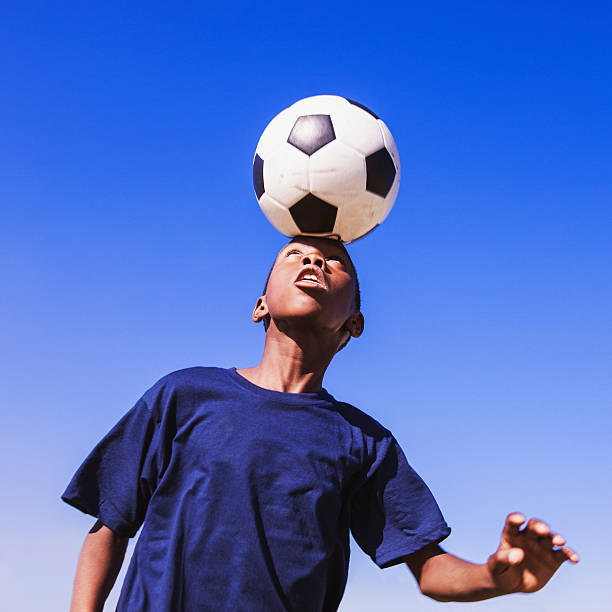istock African child heading the football 471689021