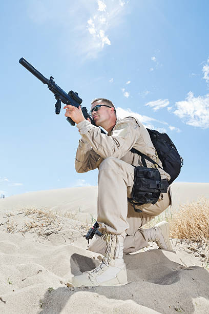 istock Military soldier in uniform aiming weapon 471689301