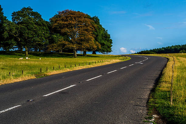 Road countryside Picture of the English countryside in South Yorkshire near Chatsworth house. A road passing by is the main interest in the picture. chatsworth house photos stock pictures, royalty-free photos & images