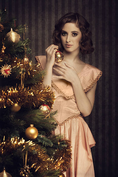 istock retro girl decorating a christmas tree 471690713