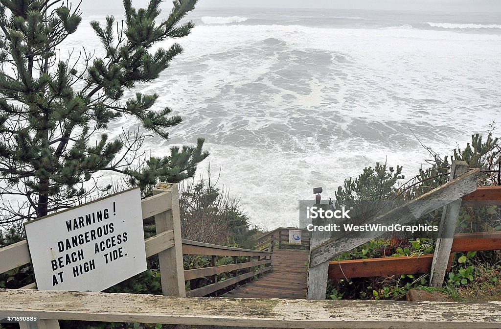 Warning sign A warning sign on a stairway leading to a beach on on the rugged Oregon Coast Beach Stock Photo