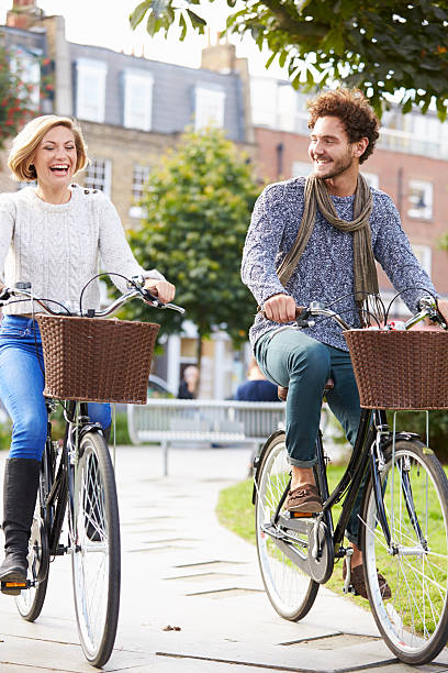 istock Couple Cycling Through Urban Park Together 471691620