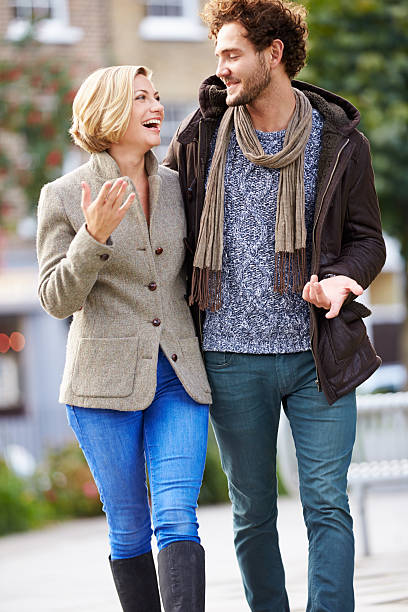 istock Young Couple Walking Through City Park Together 471691684